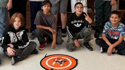 group of students in front of smartboard