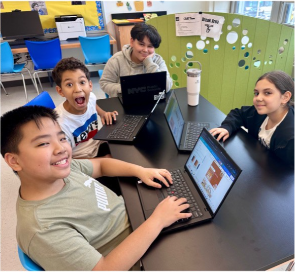 students at a table with laptops